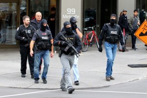 Police department employees out-of-uniform, wearing ski masks, and not displaying badge numbers. 