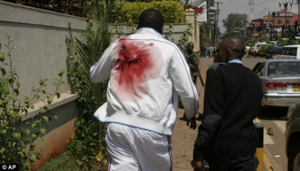 A purported victim of the Westgate Mall shooting in Nairobi, Kenya, who has just been shot in the back,  is seen runningfor his life on September 21, 2013. 
