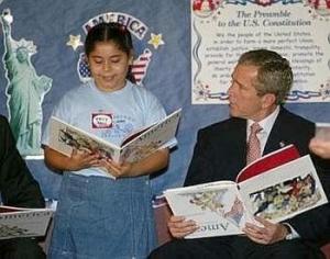 George W. Bush reads a children's book (upside down) while the U.S. comes under attack. 